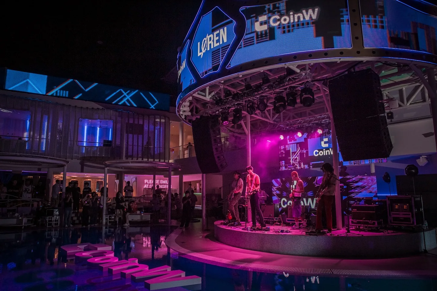 The stage over the pool, wrapped in CoinW screens