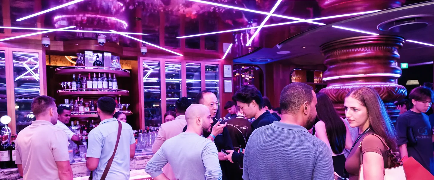 Guests at the bar under the laser-lit ceiling